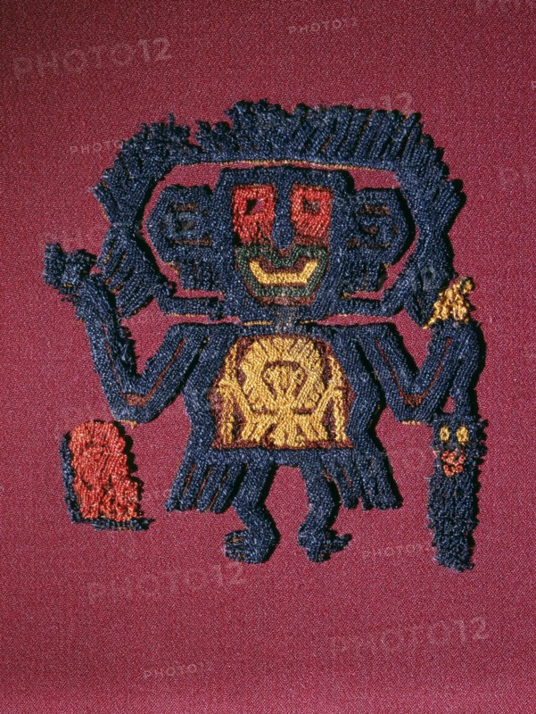 Nazca textile fragment in the form of a figure carrying a trophy head and staff