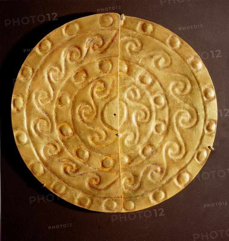 A pair of perforated embossed gold half discs, possibly earrings or pendants to be suspended from a garment or headdress