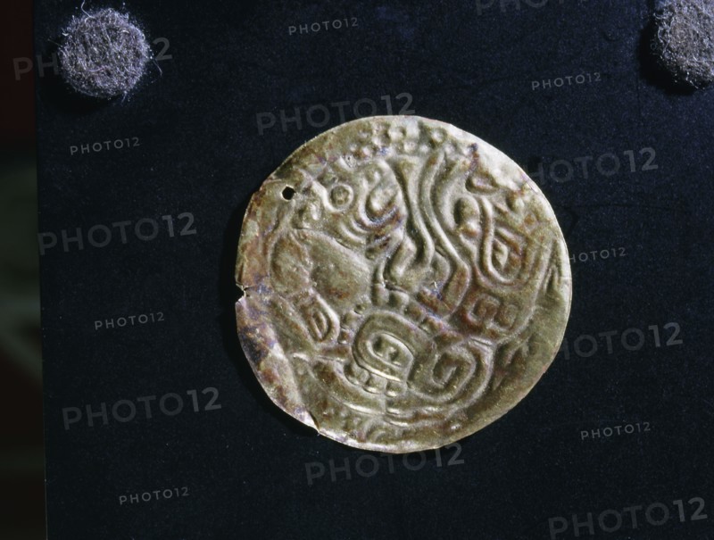 Gold disc embossed with feline images, probably made as an applique piece for a costume