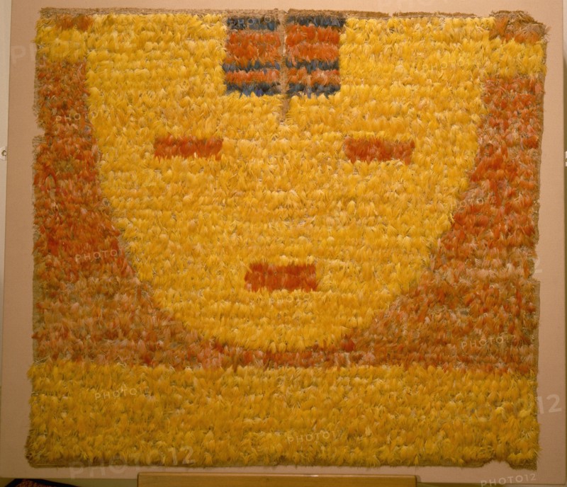 Featherwork tabbard depicting a serene sun face, or sun in repose, the personification of the sun god Inti