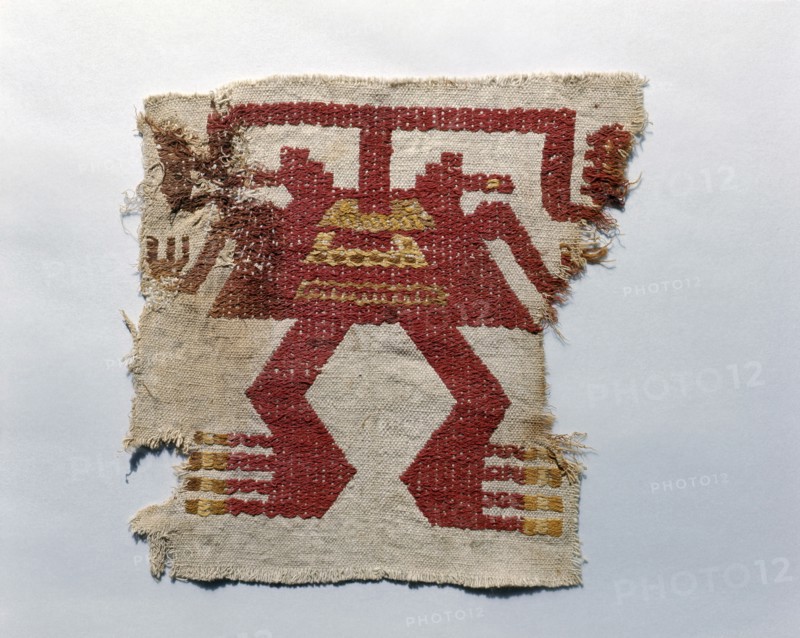 Fragment of a cloth onto which is embroidered a stylized anthropomorphic figure in dyed alpaca wool