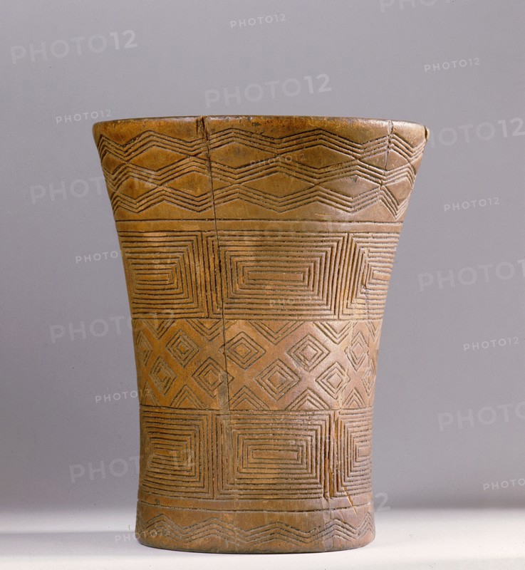 This Andean kero or ritual drinking vessel is decorated with Inca geometric designs