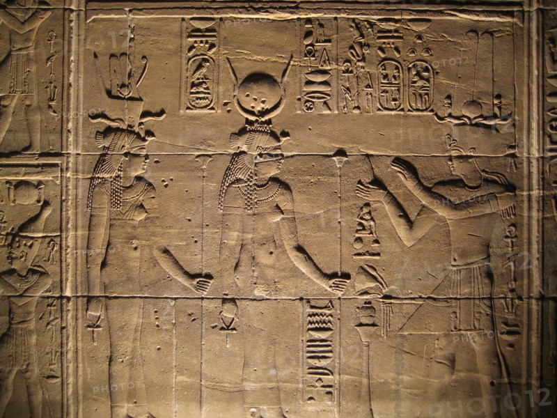 Relief depicting a pharaoh making offerings to the goddesses Isis and Hathor