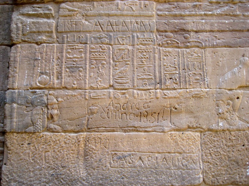 Egyptian hieroglyphic inscription on a wall of the Temple of Isis, defaced by 19th century, traveller explorer graffiti