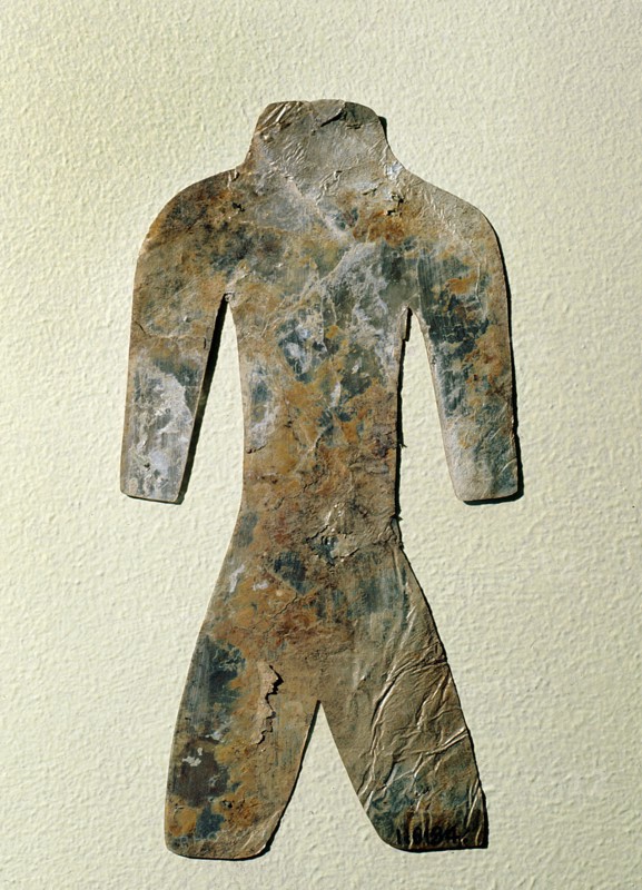 Silhouette of a mutilated human figure cut from a thin sheet of mica