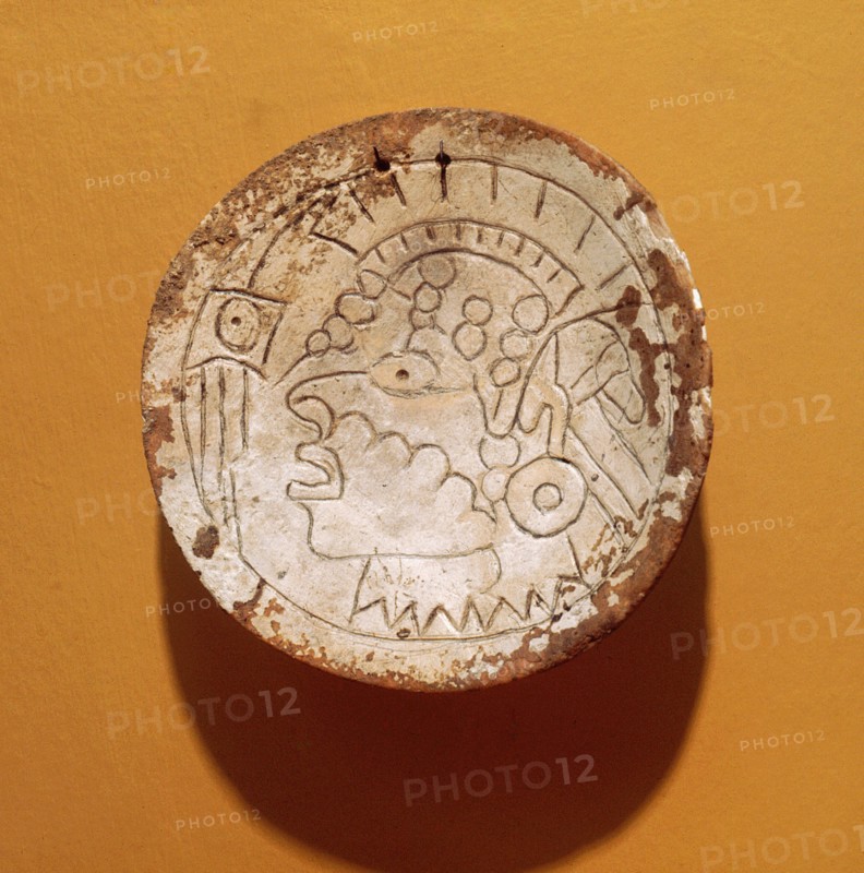 Shell gorget incised with a man with a Southern Cult headdress and ear plugs