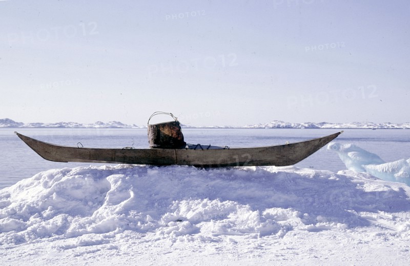 Kayak with a sealskin vest projecting up from the coaming