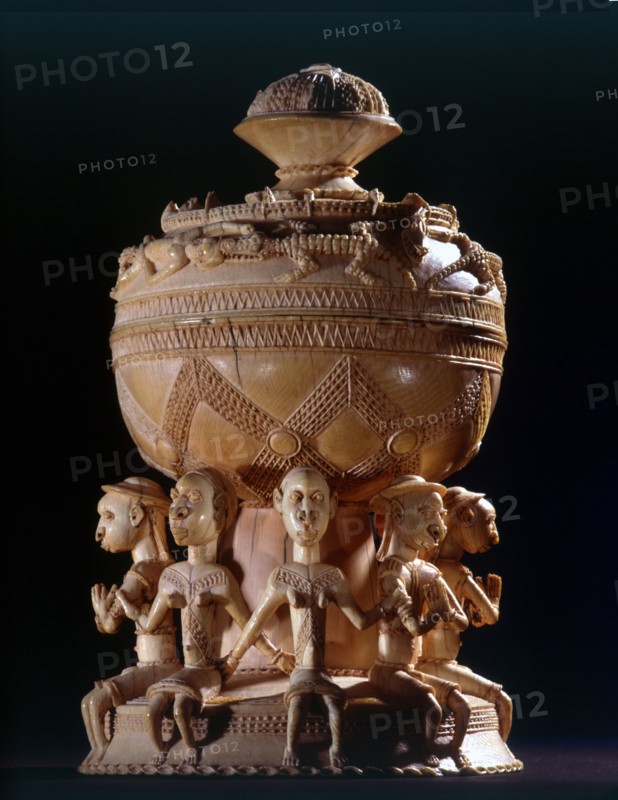 Ivory salt cellar carved in Sierra Leone for sale to Portuguese traders, depicting four male and four female figures wearing items of European dress