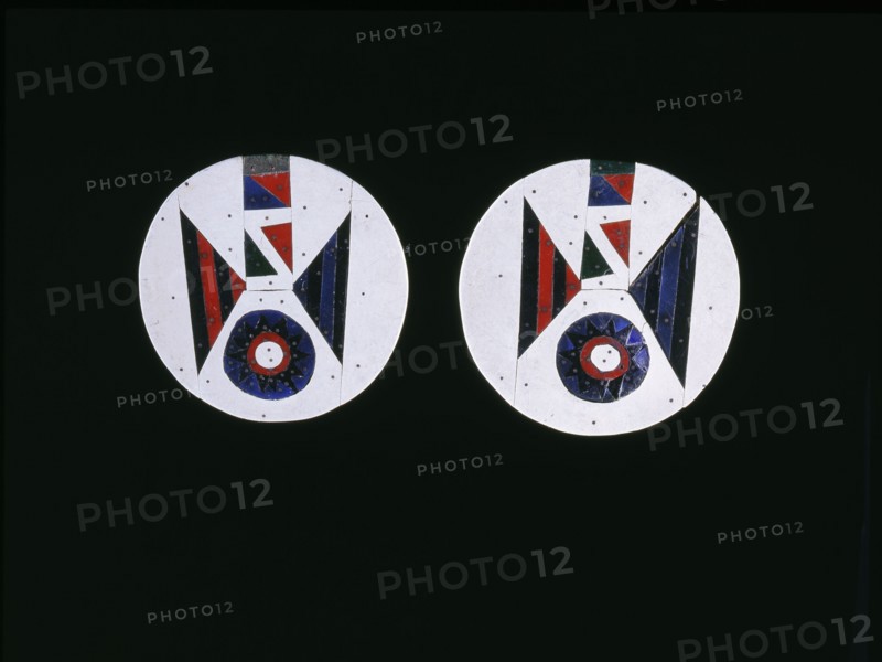 Pair of earrings made from coloured pieces of linoleum attached to a wooden disc