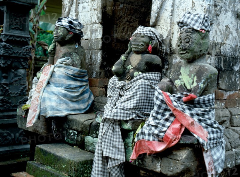Divine gatekeepers at a small family temple dressed for a festival
