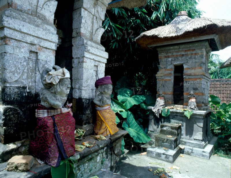 Divine gatekeepers at a small family temple dressed for a festival
