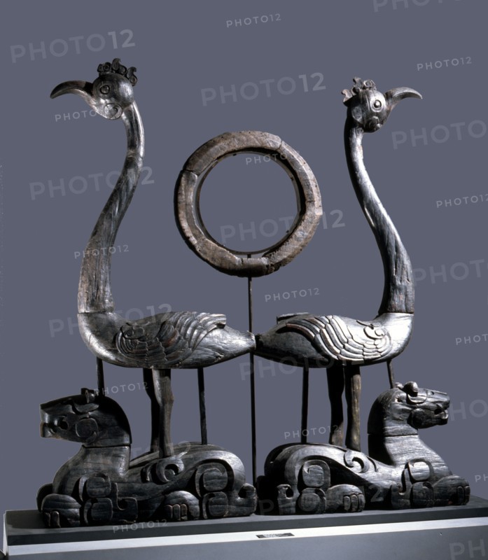 Sculpture of a pair of phoenixes resting on reclining tigers