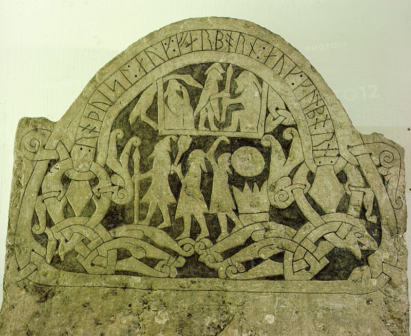 Picture stone with runic writing across the top