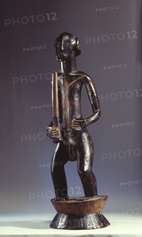 A male figure holding a club, on a flanged cylindrical base
