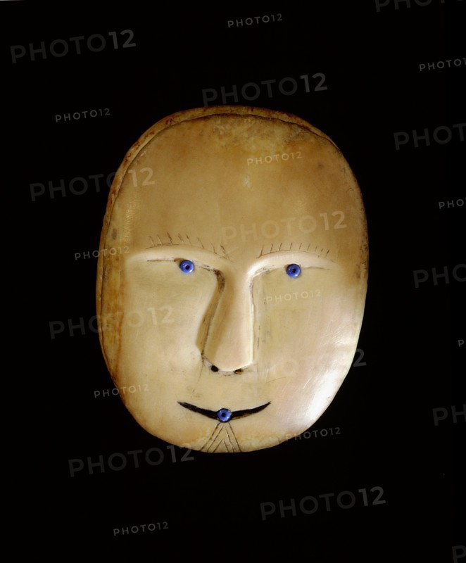 Plug from a drag float, carved in ivory in the form of a human face
