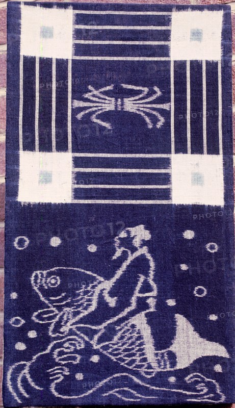 Ikat weaving with a depiction of a man riding a dolphin