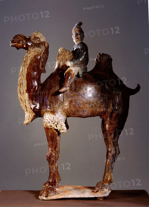 Sancai glazed tomb figure of a camel and foreign rider with an exaggeratedly large nose