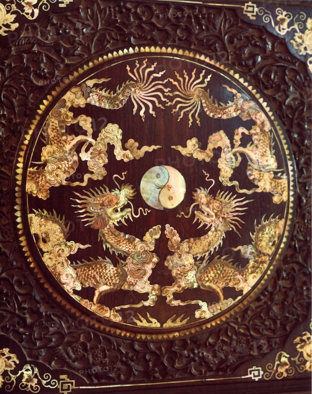 Mother of pearl inlay on a piece of dark wood furniture