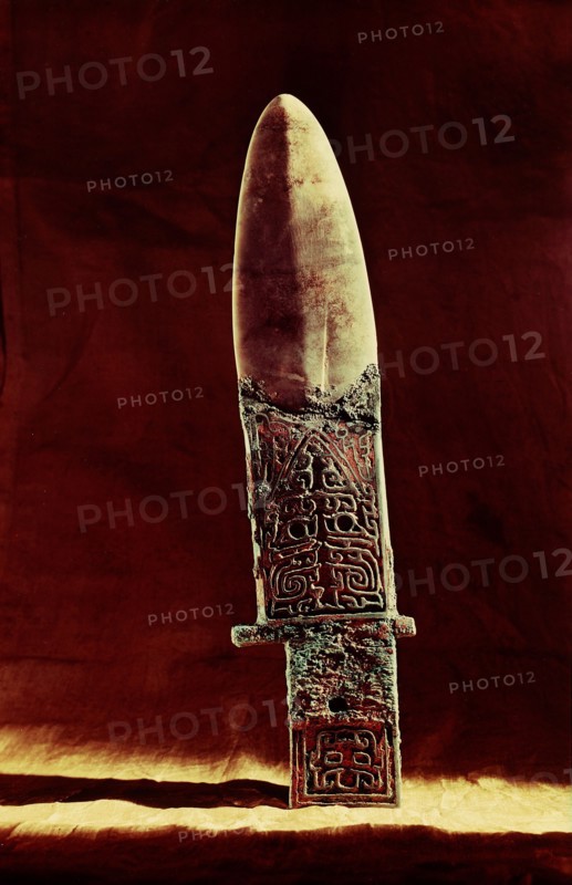Ko axe with bronze handle and jade blade, incised with designs including an animal mask