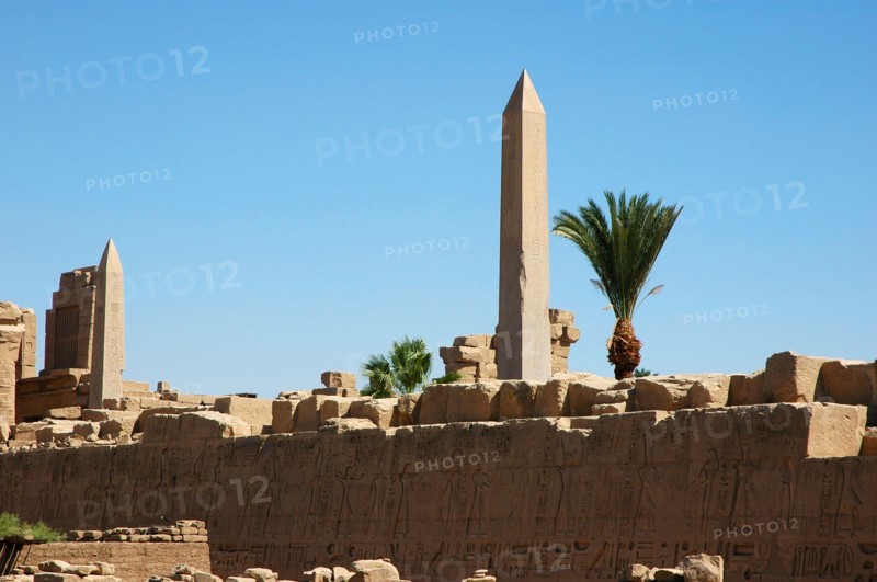 View of a hieroglyph wall and the two obelisks of Tuthmosis II (left) and Queen Hatshepsut (right) in the background