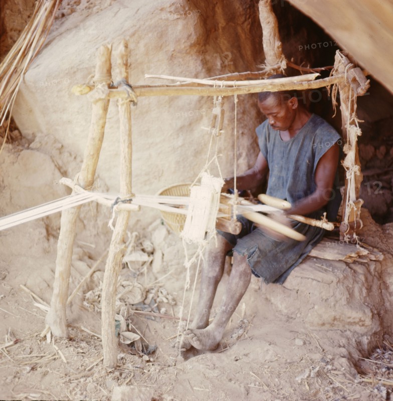 Dogon weaver, using a local variant of the narrow-strip double-heddle loom common throughout West Africa