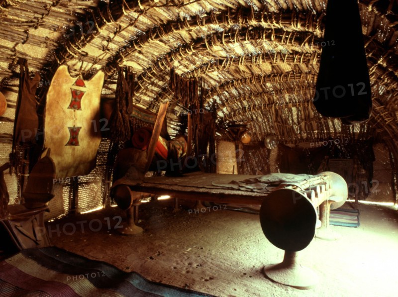 An interior of a tent 'house' with a large bed