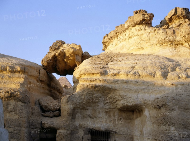 The Great Pyramid of Cheops seen through the crumbling superstructure of the Old Kingdom mastabas