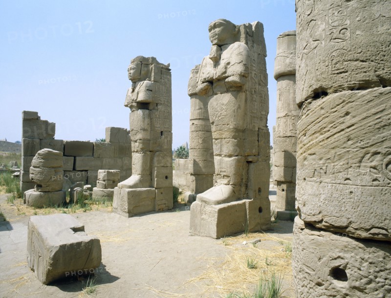 Two statues in the entrance of a corridor