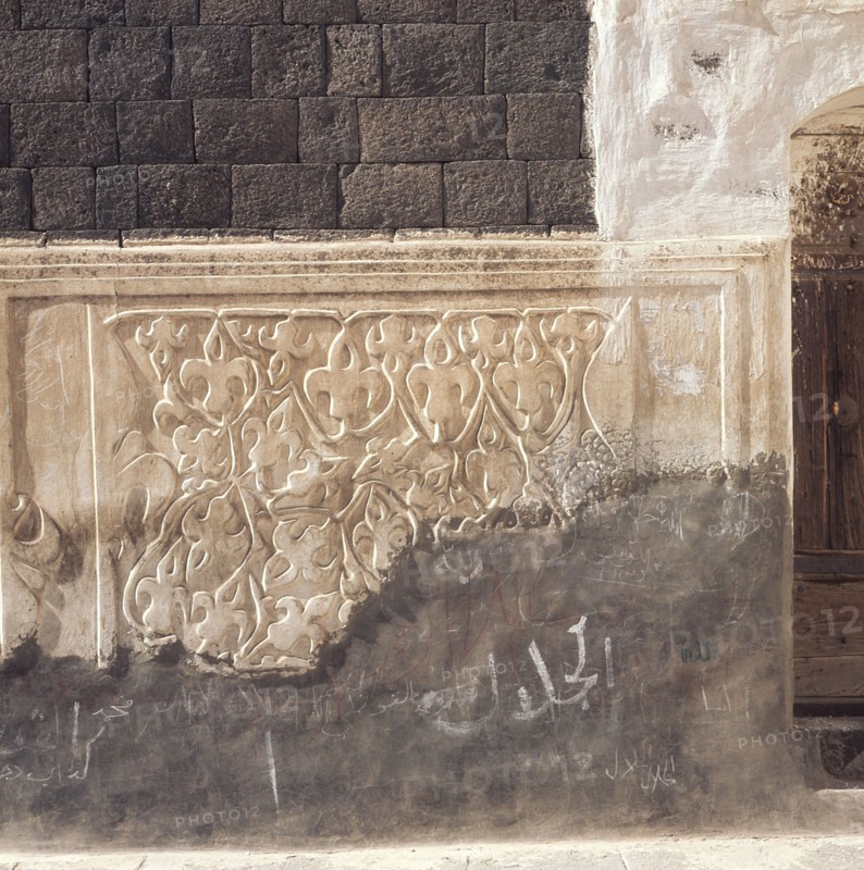Incised plasterwork beside a doorway