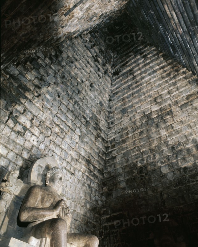 A statue of the seated Buddha in Chandi Mendut, one of the several temples associated with Borobudur