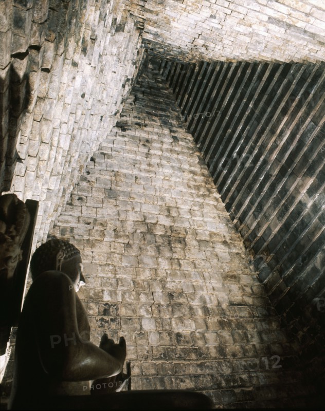A statue of the seated Buddha in Chandi Mendut, one of the several temples associated with Borobudur