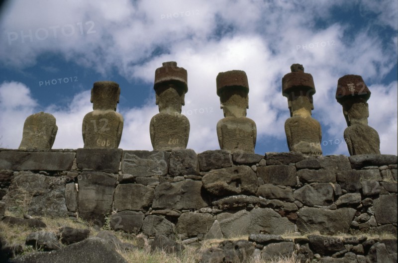 of 6 "Moai" figures re-erected on a platform (ahu) and "top knots" at Anakena Bay