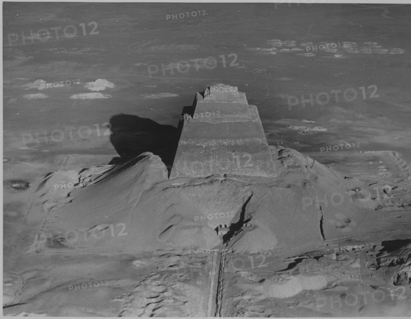 The pyramid of Meidum, surrounded by the debris of its collapsed outer covering, photographed in the 1920's