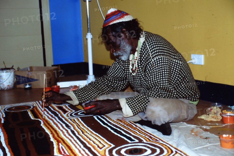 Balgo Community desert artist, the late Tjumpo Tjapanangka, working on a dot painting at the Warlayirti Culture Centre in the north-west desert region of Western Australia south of Halls Creek