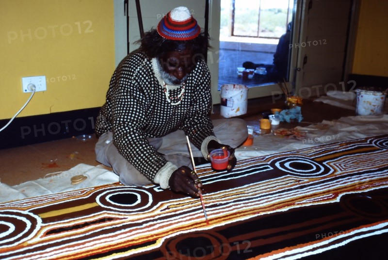 Balgo Community desert artist, the late Tjumpo Tjapanangka, working on a dot painting at the Warlayirti Culture Centre in the north-west desert region of Western Australia south of Halls Creek