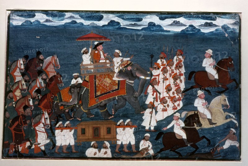 An official of the British East India Company riding on an elephant with an escort of foot soldiers and mounted Indian retainers