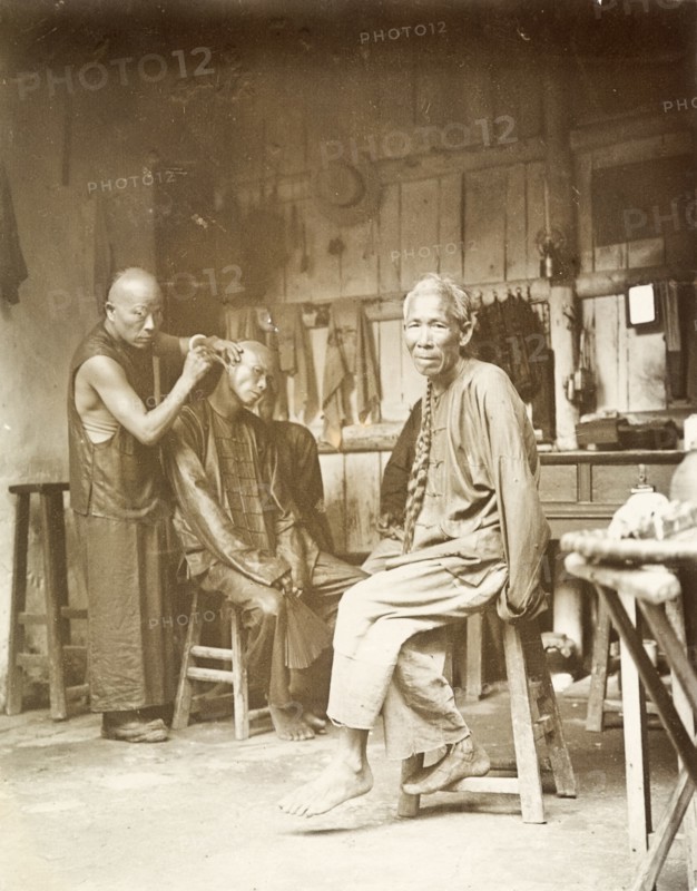 Ear cleaning at a barber's shop, China