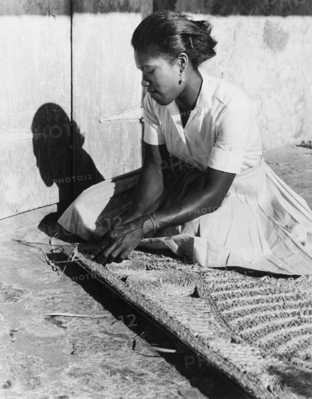 Weaving a palm mat, Dominica