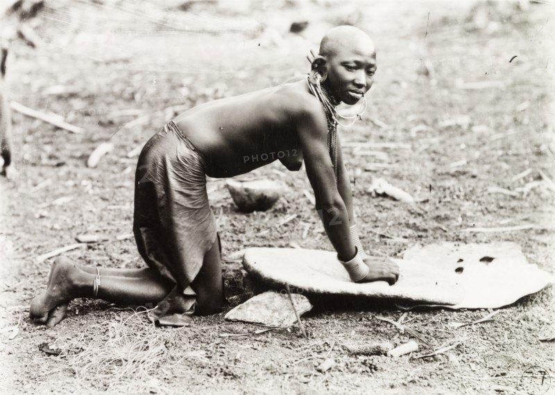 Kikuyu woman grinding millet