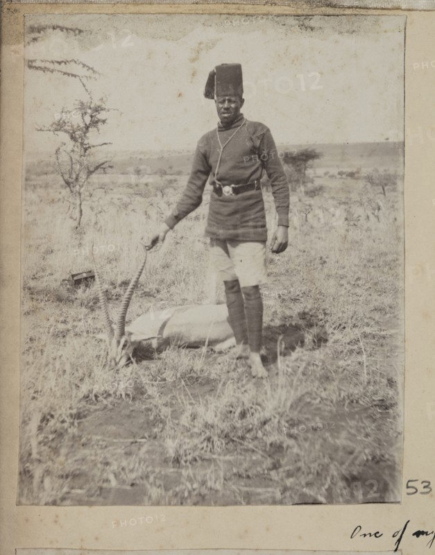 Uniformed servant with dead Thomson's gazelle