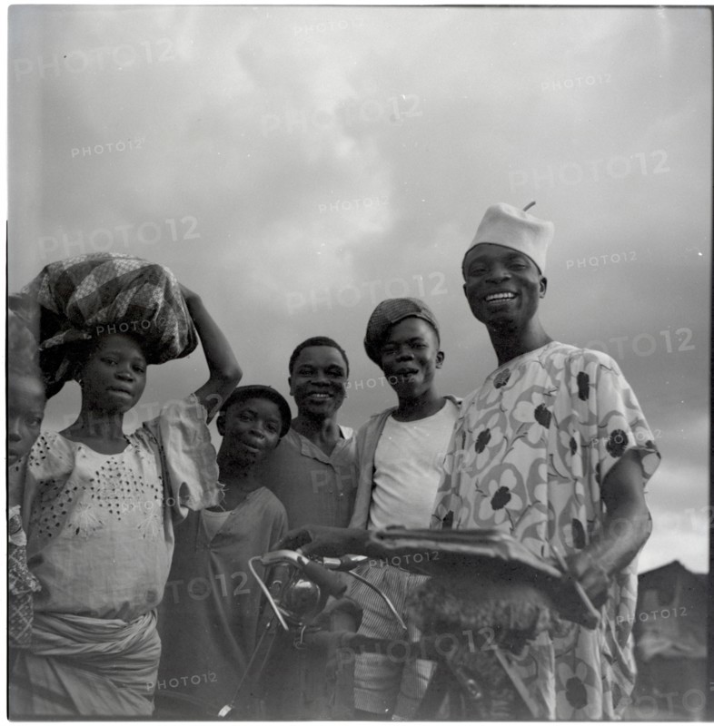 Ibadan: Town and market, group of men with bicycle