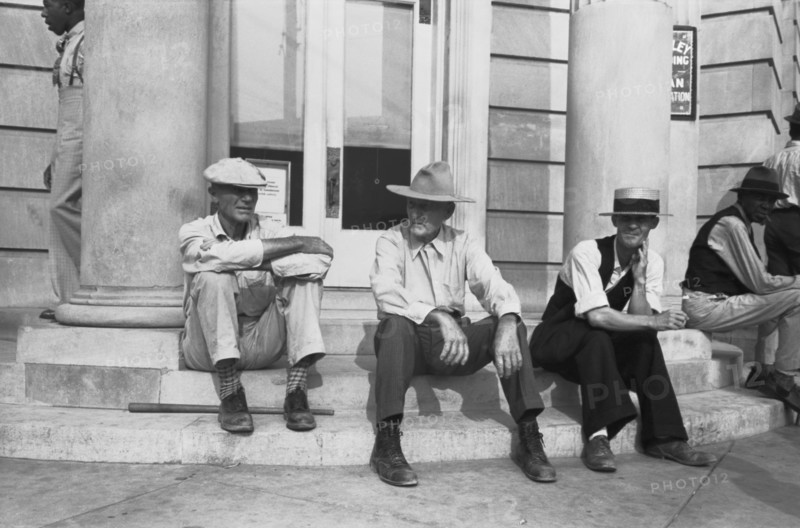 Men Sitting On Bank Steps