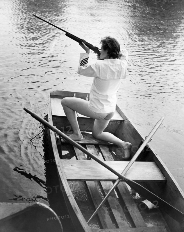 Woman Firing A Rifle