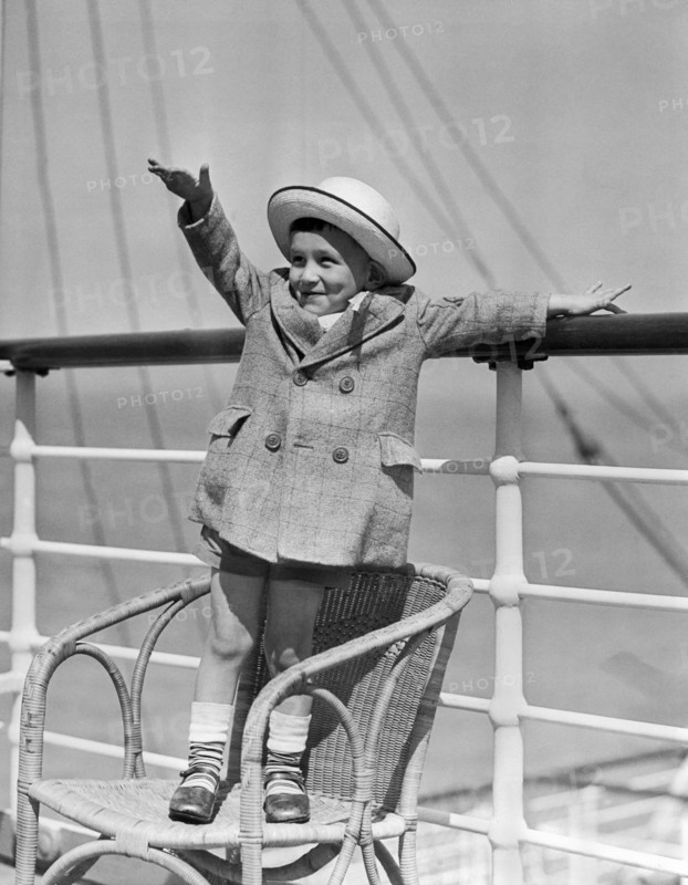 Boy Waving On Ocean Liner