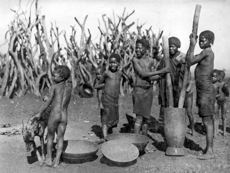 African Girls Grinding Corn