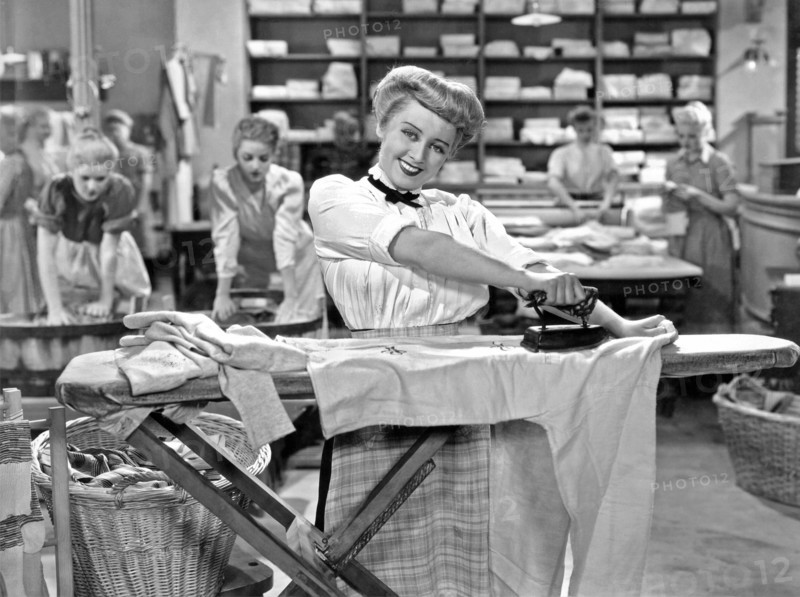Woman Ironing In Laundry