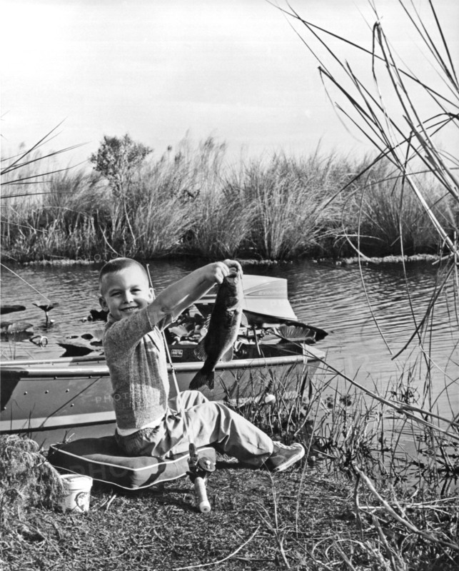 A Boy Holds Up His Catch