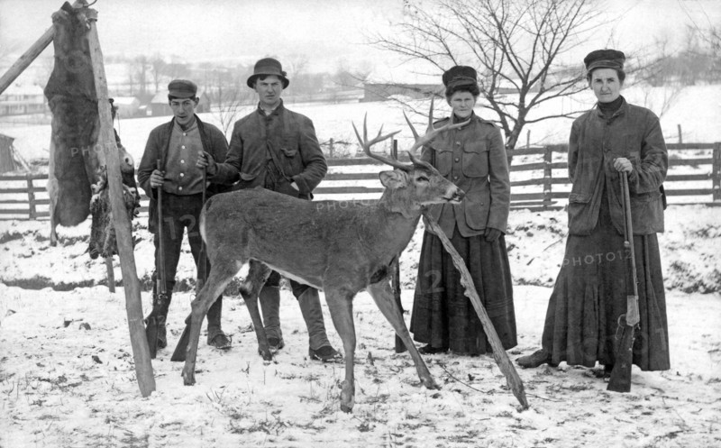 Four hunters and their game.