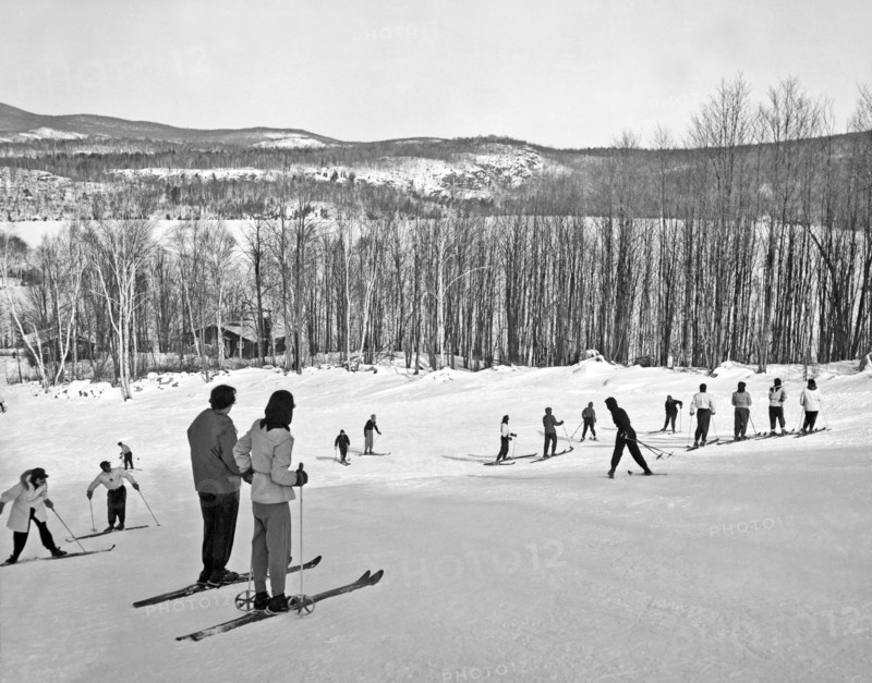 Two Skiers Pause On A Slope