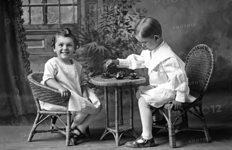 Boy Pours Sister A Cup Of Tea